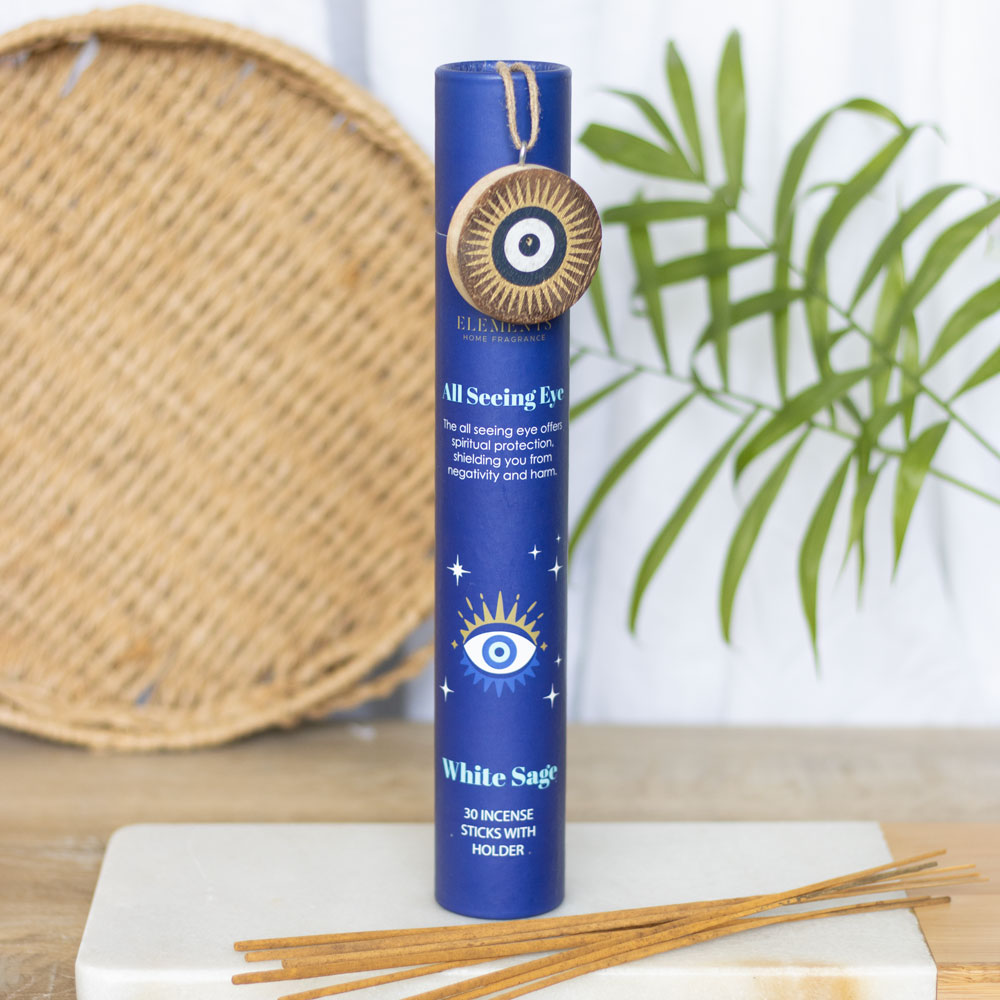 Blue cylindrical incense stick container with 'All Seeing Eye' design on a wooden surface with incense sticks.
