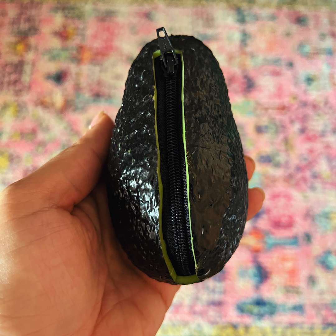 hand holding avocado coin purse