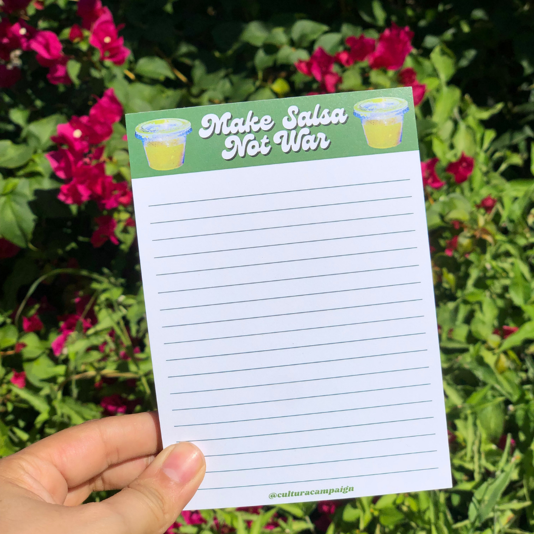 Make Salsa Not War Notepad in front of flowers
