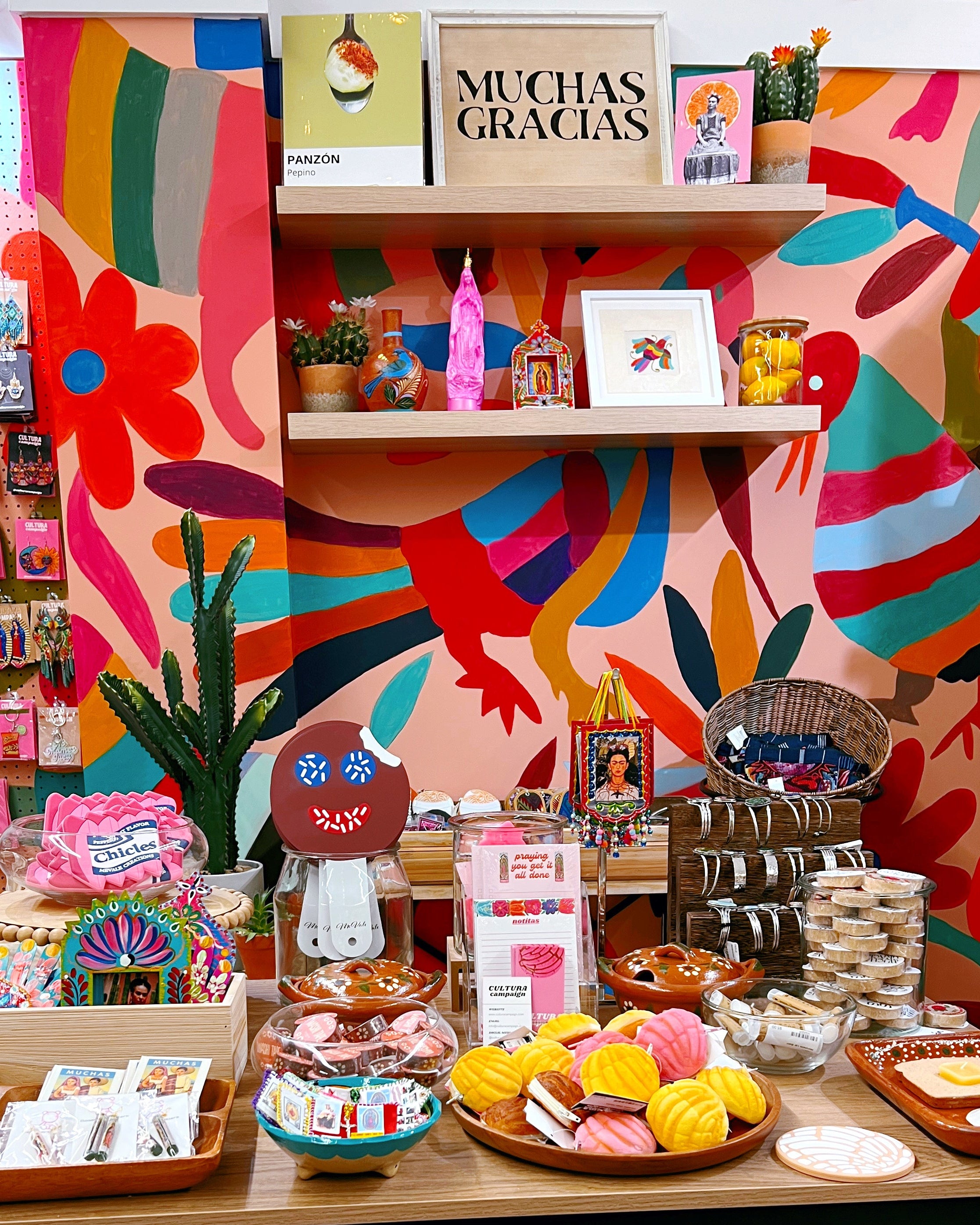Colorful store interior with various products on display against a vibrant wall.