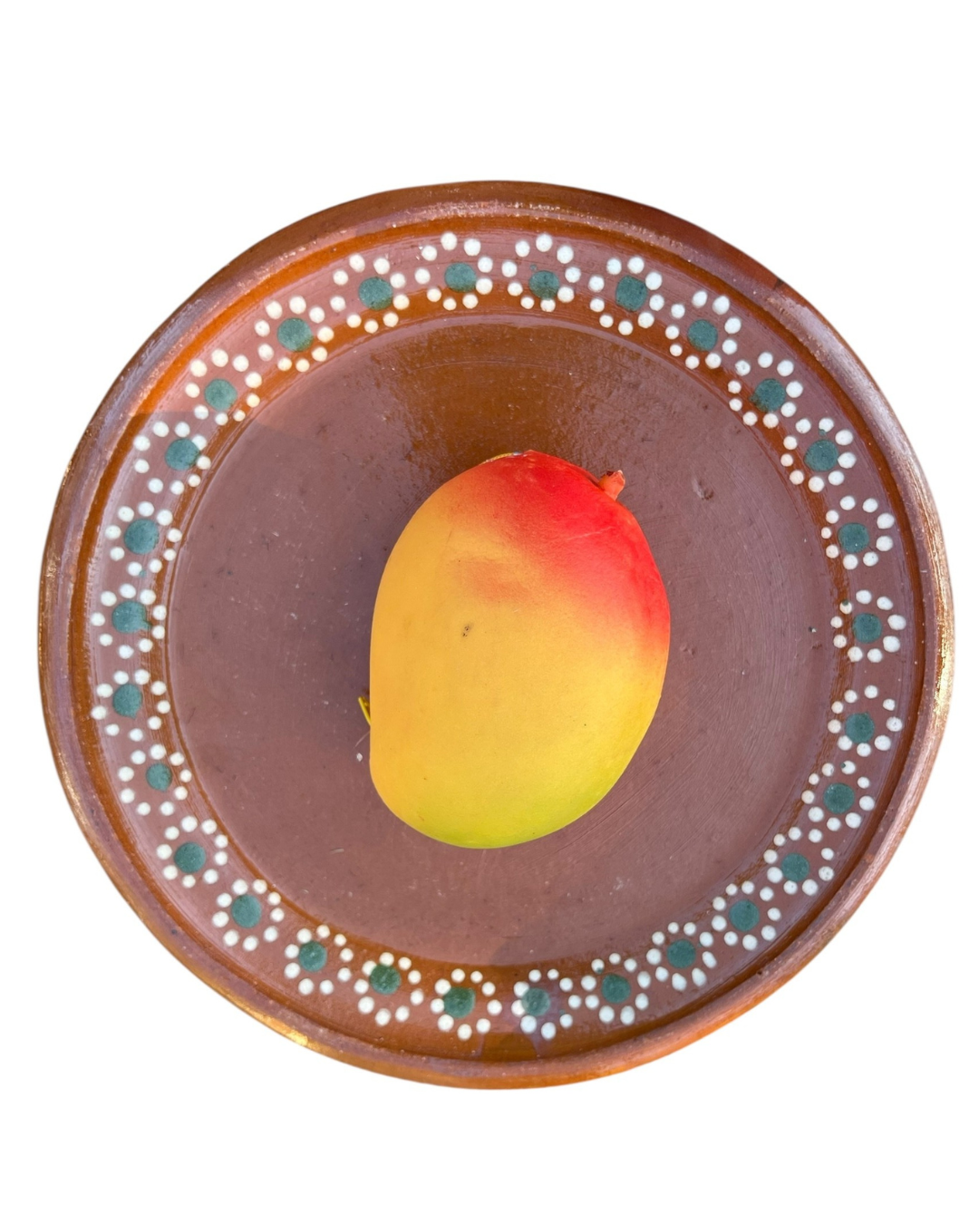 Mango coin purse on a decorative brown plate with a white background