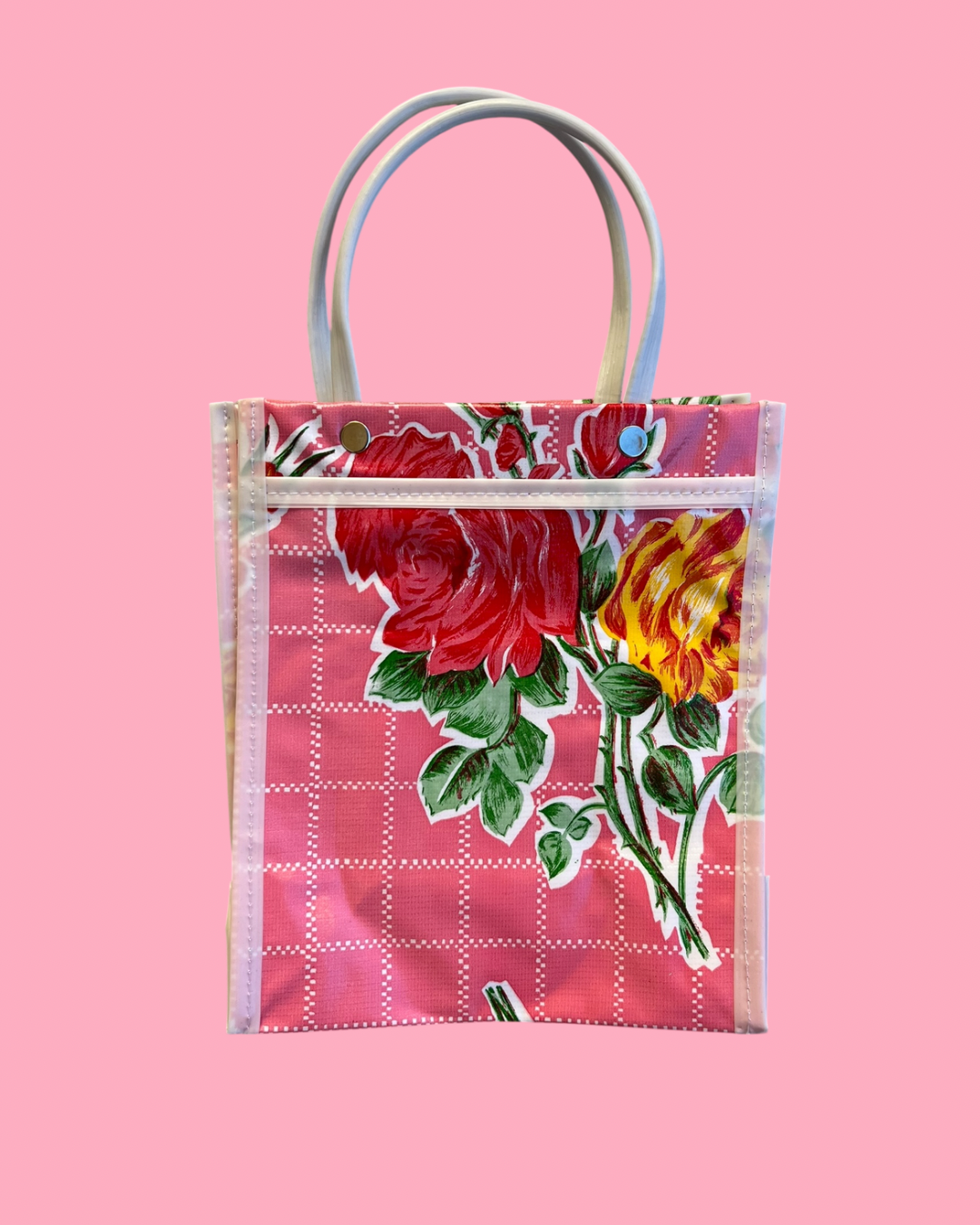 Floral tote bag with red and yellow roses on a pink background