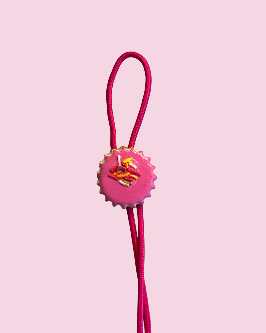 Pink pan dulce cookie bolo tie on pink background